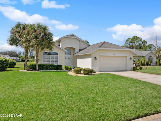 view of front of property with a garage and a front yard