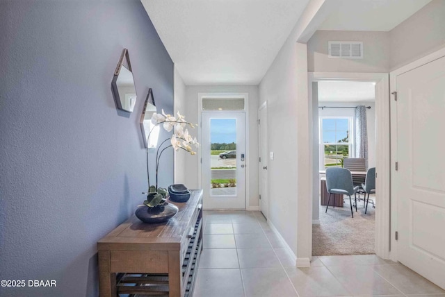 entryway with light colored carpet