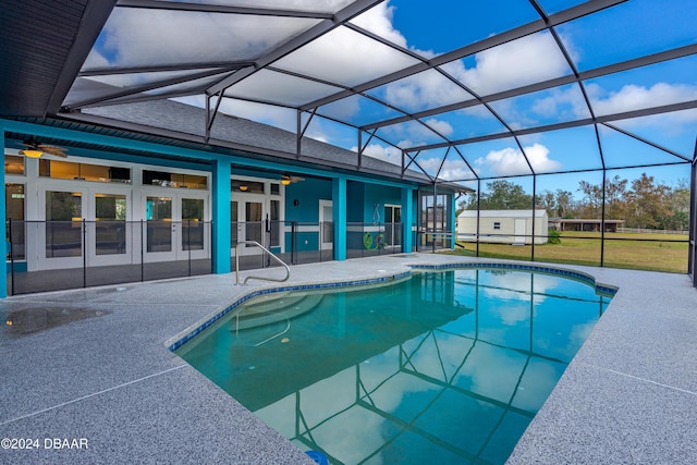 view of pool featuring ceiling fan, glass enclosure, and french doors