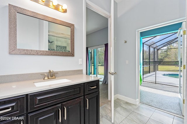 bathroom with tile patterned flooring, vanity, and a healthy amount of sunlight