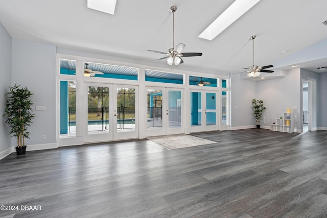 unfurnished living room featuring french doors, lofted ceiling with skylight, and dark wood-type flooring