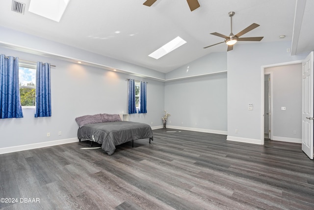 bedroom featuring ceiling fan, vaulted ceiling with skylight, and dark wood-type flooring