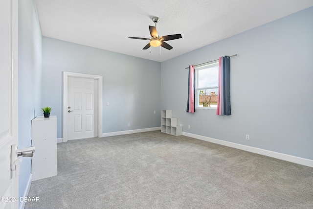 unfurnished room featuring light colored carpet and ceiling fan