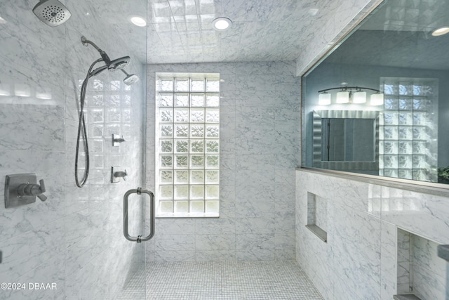 bathroom featuring a shower with shower door