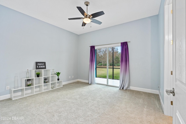 carpeted spare room featuring ceiling fan