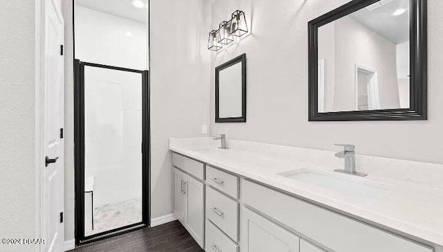 bathroom with vanity and hardwood / wood-style flooring