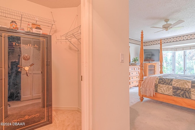 bedroom featuring carpet, baseboards, and a textured ceiling