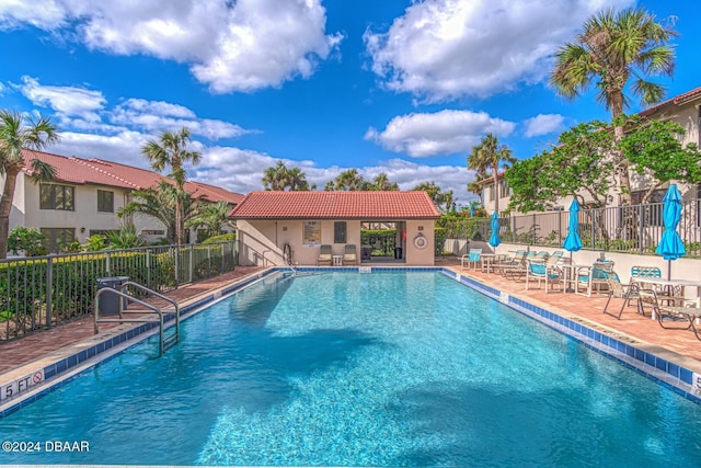 pool featuring a patio and fence