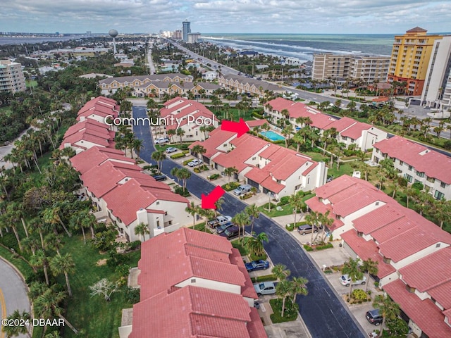 drone / aerial view with a city view and a water view