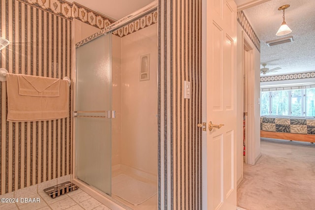 ensuite bathroom with visible vents, wallpapered walls, a shower stall, a textured ceiling, and connected bathroom