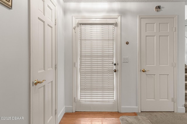 entryway featuring baseboards and light wood-style floors