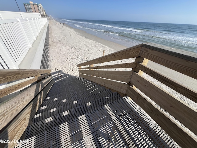 surrounding community with a beach view and a water view