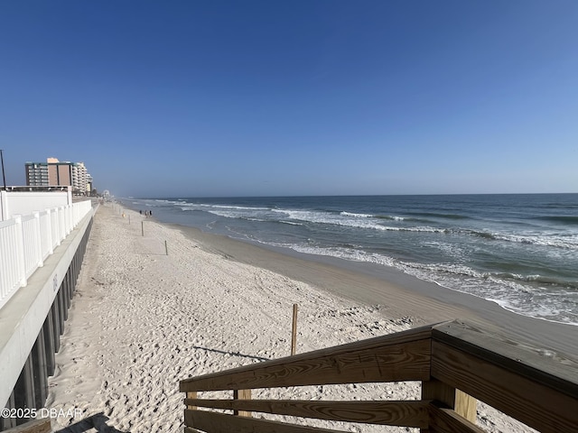 view of water feature with a view of the beach and fence