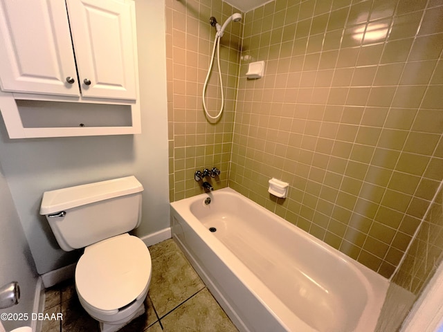 full bathroom featuring tile patterned flooring, toilet, baseboards, and washtub / shower combination