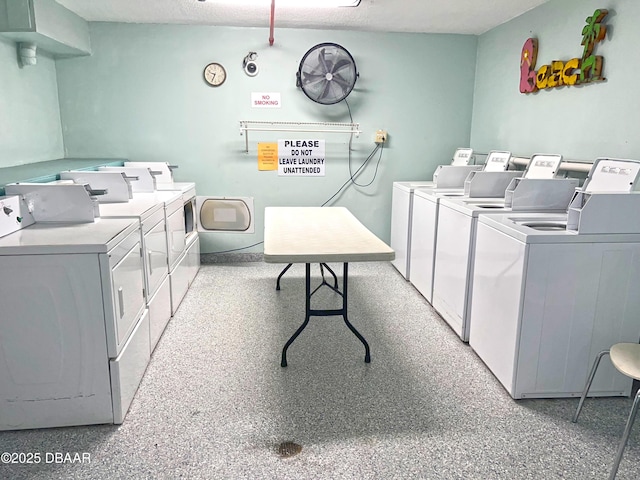 community laundry room featuring washer and clothes dryer