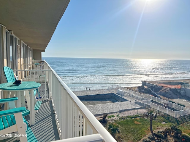 balcony with a view of the beach and a water view