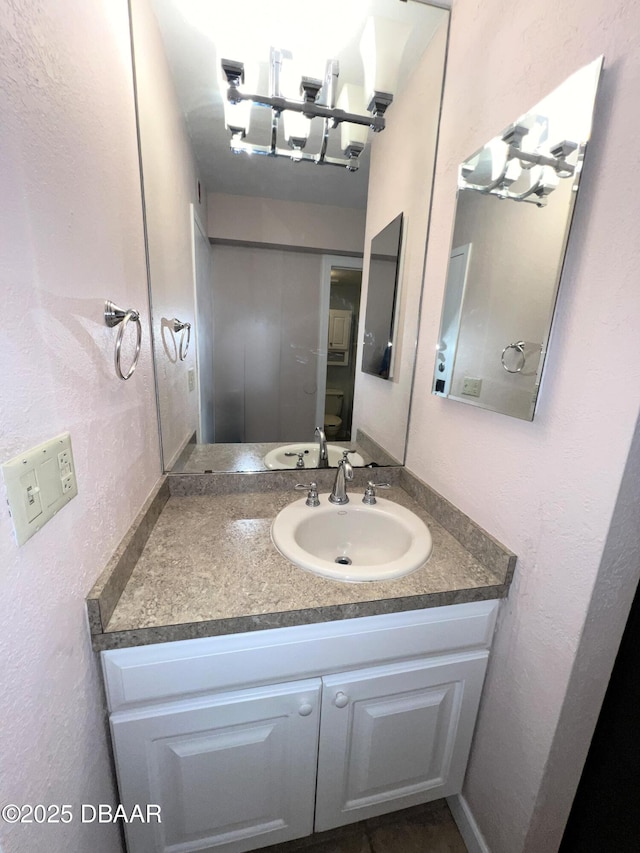 bathroom featuring vanity and a chandelier