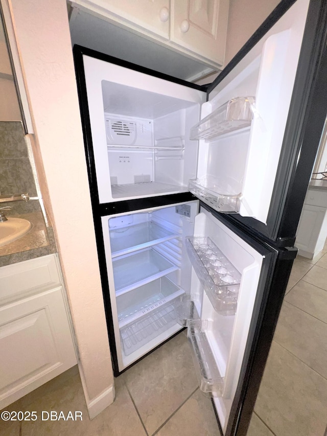 interior details featuring white cabinets and a sink