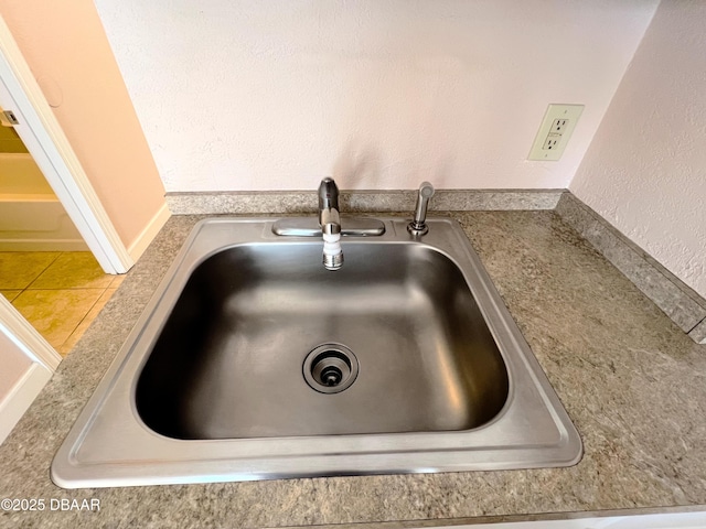 room details with a textured wall and a sink