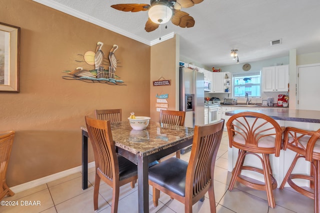 2801 N Halifax Ave N Unit 238, Daytona Beach, FL 32118 - dining room with a ceiling fan, light tile patterned floors, a textured ceiling, and crown molding