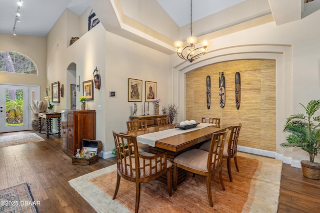 1324 Munster Cir, Ormond Beach, FL 32174 - dining area featuring high vaulted ceiling, wood-type flooring, and a chandelier