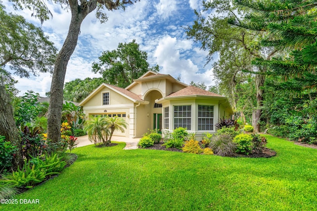 1324 Munster Cir, Ormond Beach, FL 32174 - view of front facade featuring stucco siding, a garage, a front yard, and concrete driveway