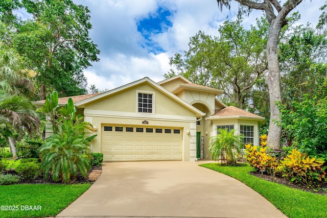 1324 Munster Cir, Ormond Beach, FL 32174 - view of front of home with stucco siding, driveway, and a garage