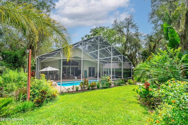 1324 Munster Cir, Ormond Beach, FL 32174 - rear view of house with a yard, a patio, an outdoor pool, and glass enclosure
