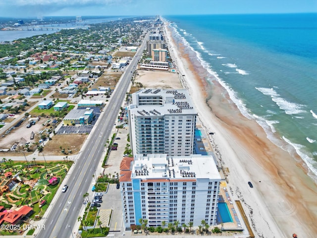 drone / aerial view of extended coastline and apartment complex / building