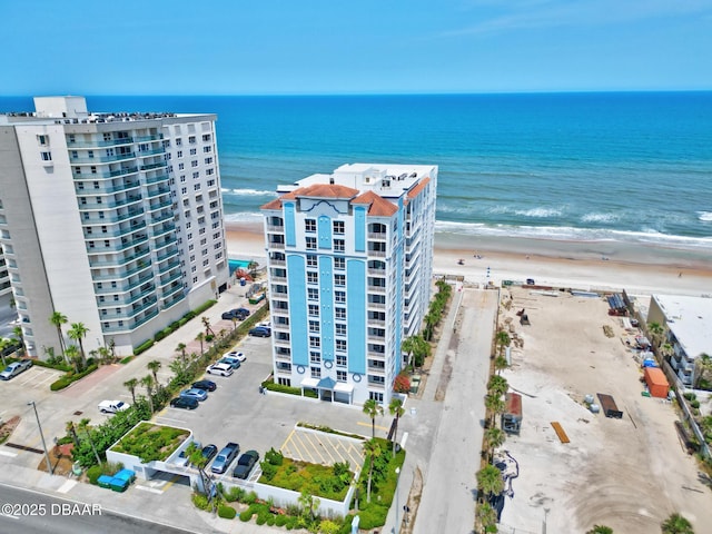drone / aerial view of apartment complex and expansive coastline