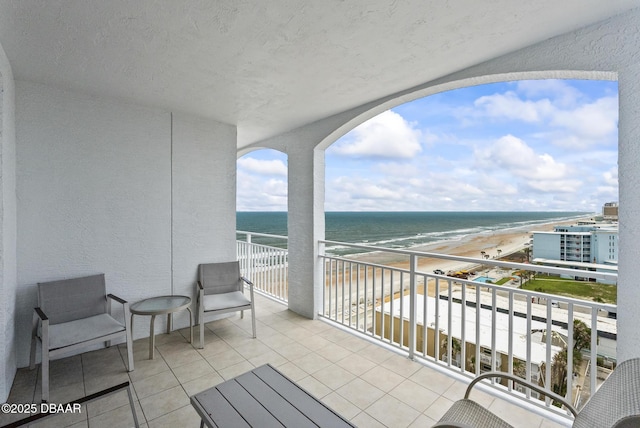 balcony with view of water and beach