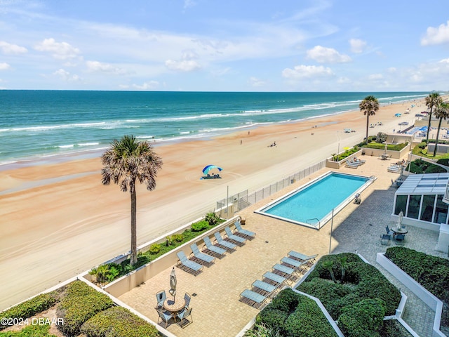 drone / aerial view featuring a view of the beach and a water view