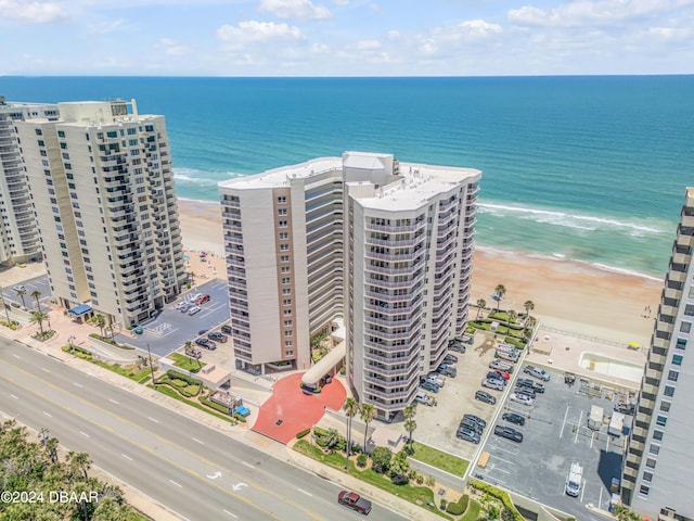 birds eye view of property featuring a view of the beach and a water view