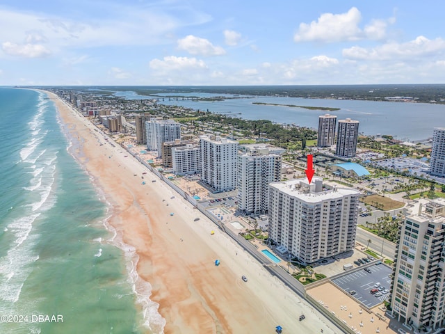 bird's eye view with a water view and a beach view