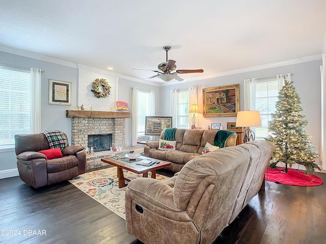 living room with a brick fireplace, ceiling fan, dark hardwood / wood-style floors, and ornamental molding