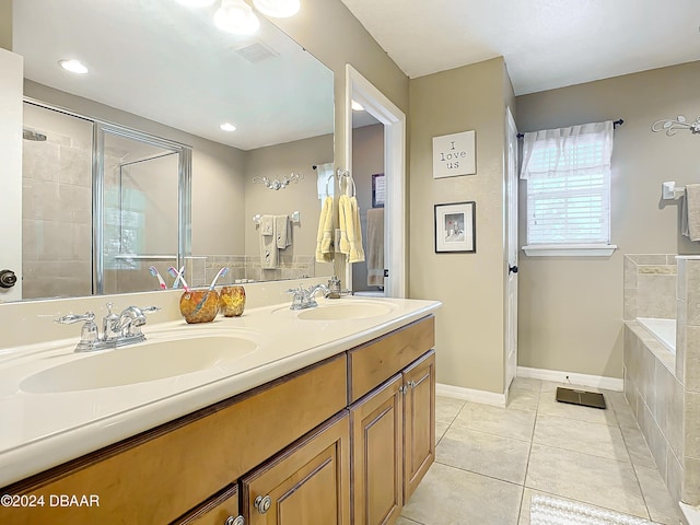 bathroom with tile patterned flooring, vanity, and separate shower and tub