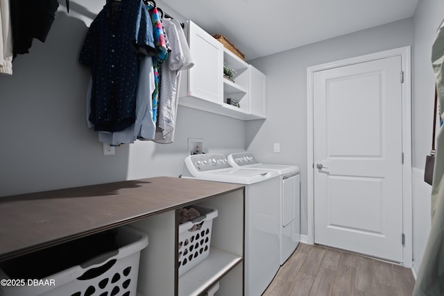 2518 Hoptree Ln, Edgewater, FL 32141 - laundry room featuring washing machine and dryer, light wood-type flooring, and cabinet space