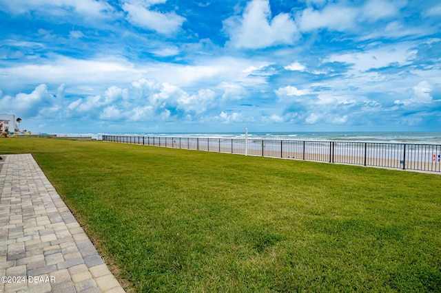 view of yard featuring a view of the beach and a water view