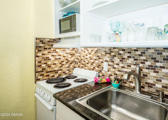 kitchen featuring tasteful backsplash, sink, white cabinets, custom exhaust hood, and white appliances