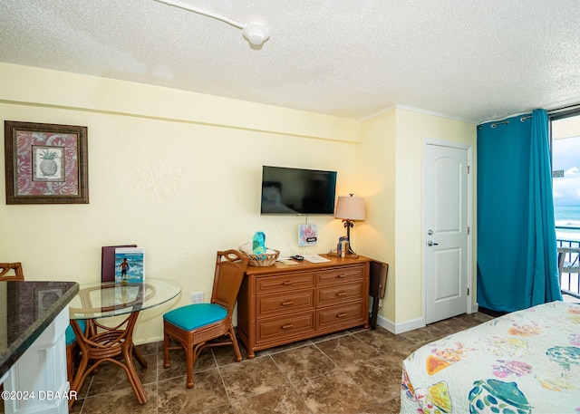 bedroom featuring multiple windows and a textured ceiling