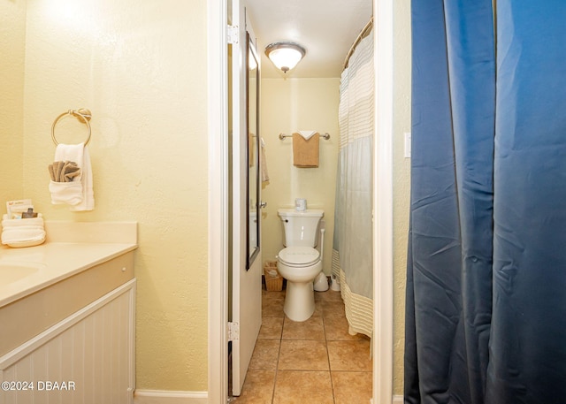 bathroom featuring toilet, vanity, and tile patterned flooring