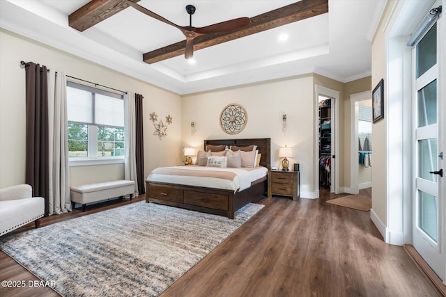 4 Oakview Ct, Palm Coast, FL 32137 - bedroom featuring a walk in closet, wood finished floors, a closet, beamed ceiling, and baseboards