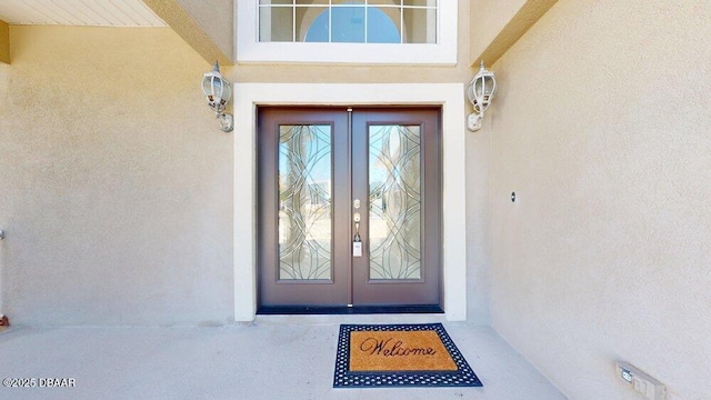 property entrance with stucco siding