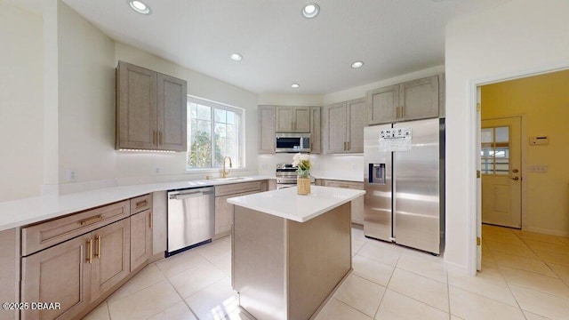 kitchen with light tile patterned floors, a kitchen island, appliances with stainless steel finishes, and recessed lighting