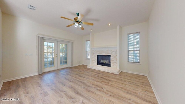 unfurnished living room featuring visible vents, a ceiling fan, french doors, light wood finished floors, and baseboards