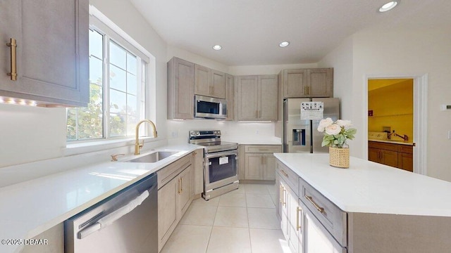 kitchen with a sink, recessed lighting, stainless steel appliances, light countertops, and light tile patterned floors