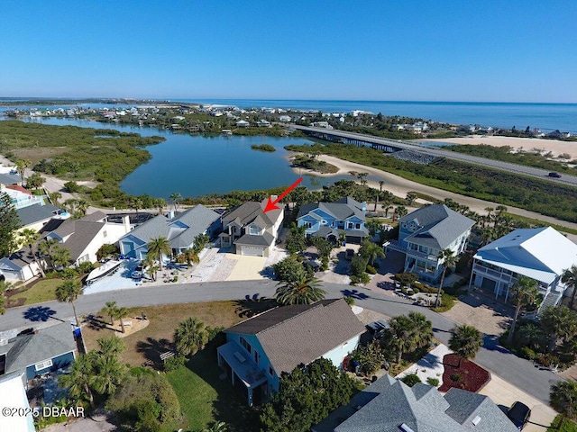 drone / aerial view with a water view and a residential view