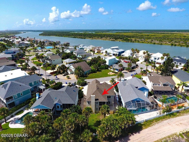 birds eye view of property with a residential view and a water view