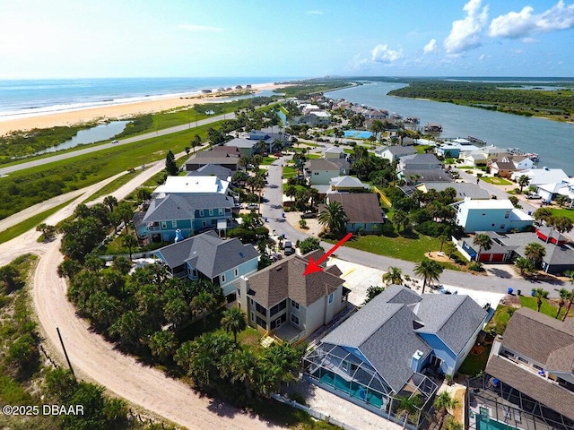 birds eye view of property featuring a residential view, a beach view, and a water view