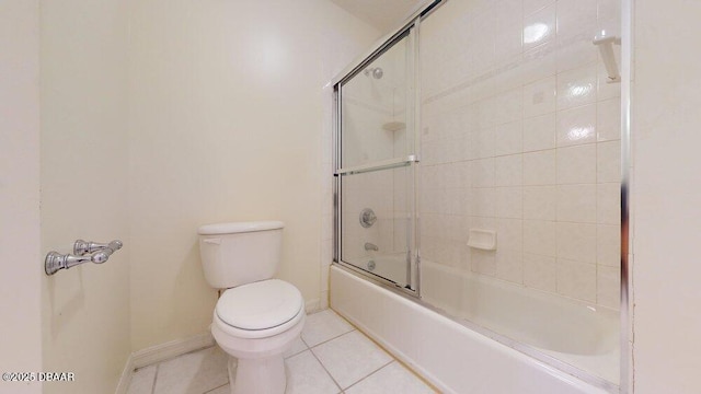 full bath with tile patterned flooring, toilet, enclosed tub / shower combo, and baseboards